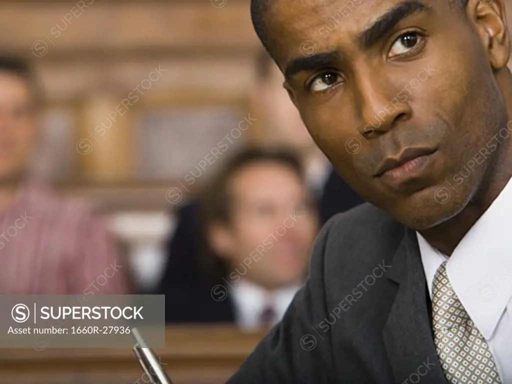 Portrait of a male lawyer sitting in a courtroom