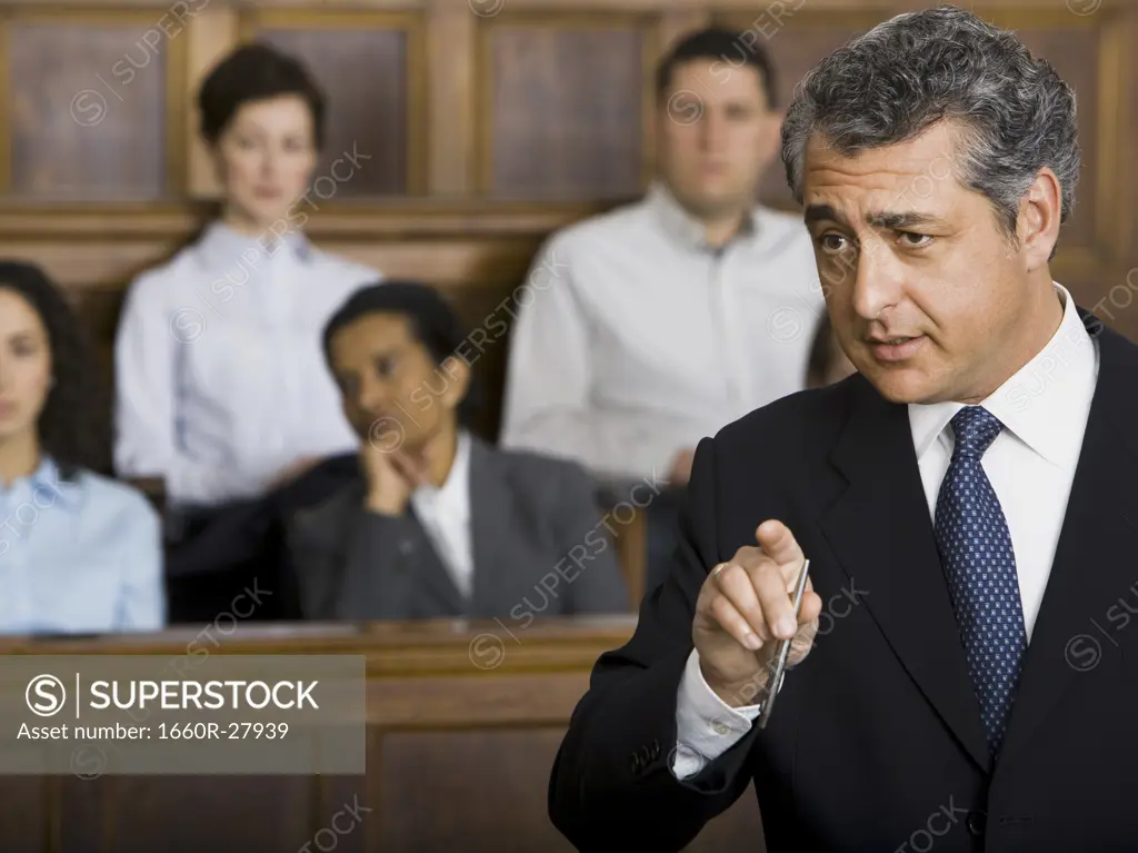 A male lawyer talking in a courtroom