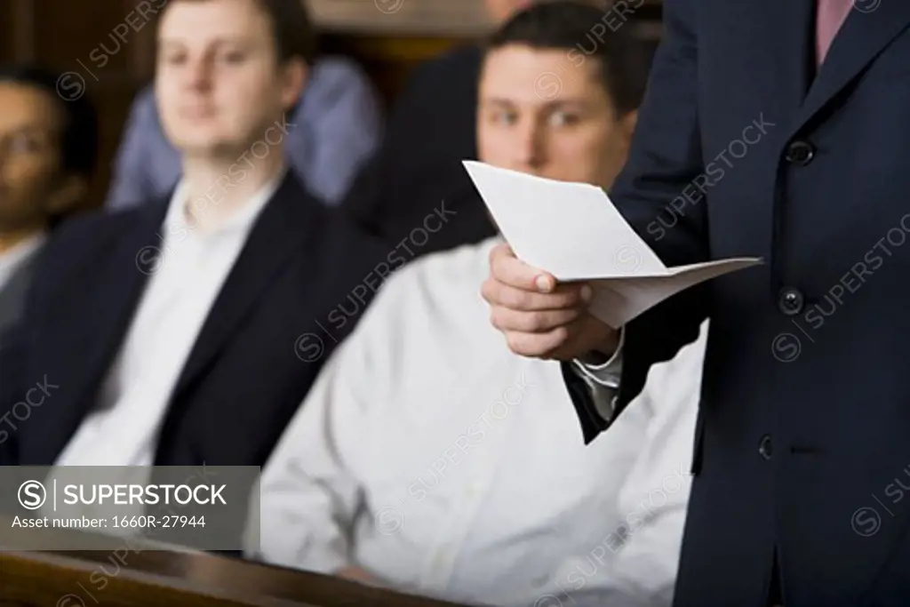 Juror standing in a jury box and reading the verdict