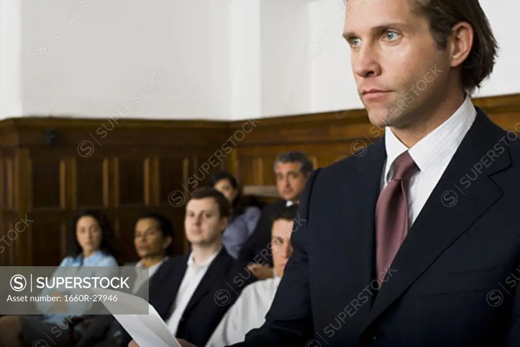 Juror standing in a jury box and reading the verdict