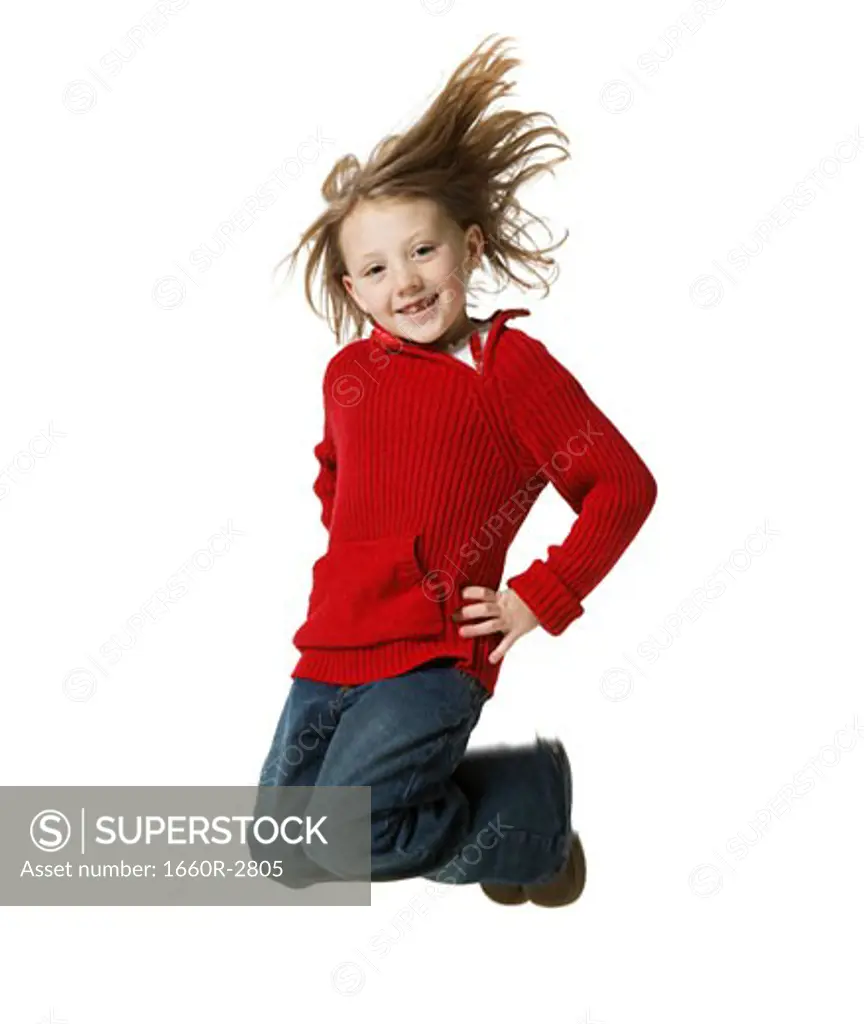 Portrait of a girl jumping with arms akimbo