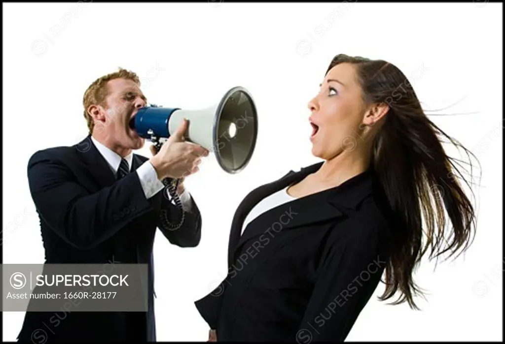 Close-up of a businessman shouting at a teenage girl through a megaphone