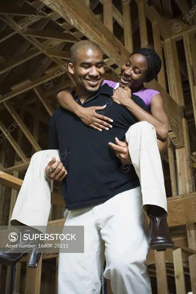 Portrait of a young woman riding piggyback on a young man