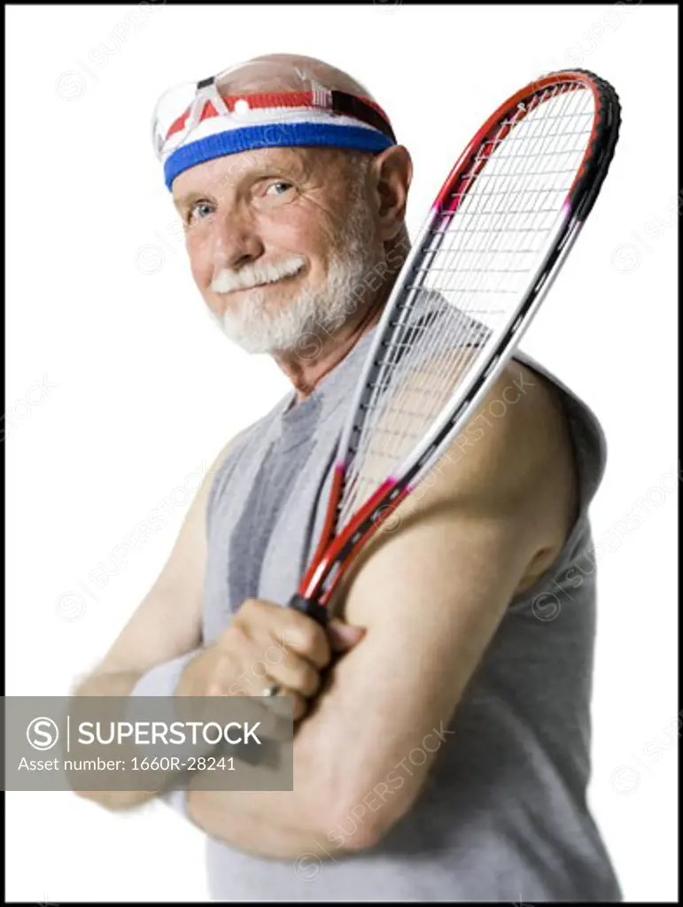 Portrait of a senior man holding a tennis racket