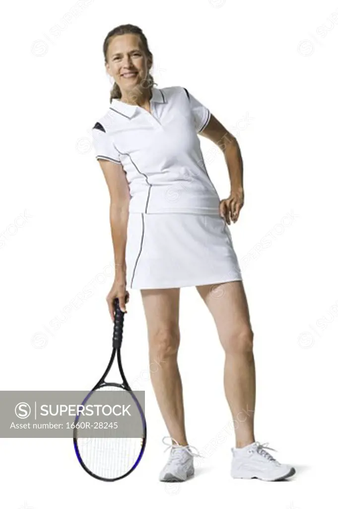 Portrait of a senior woman holding a tennis racket and smiling