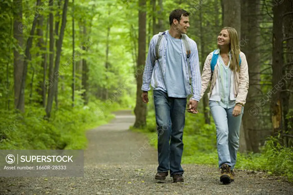 Young couple walking and holding hands