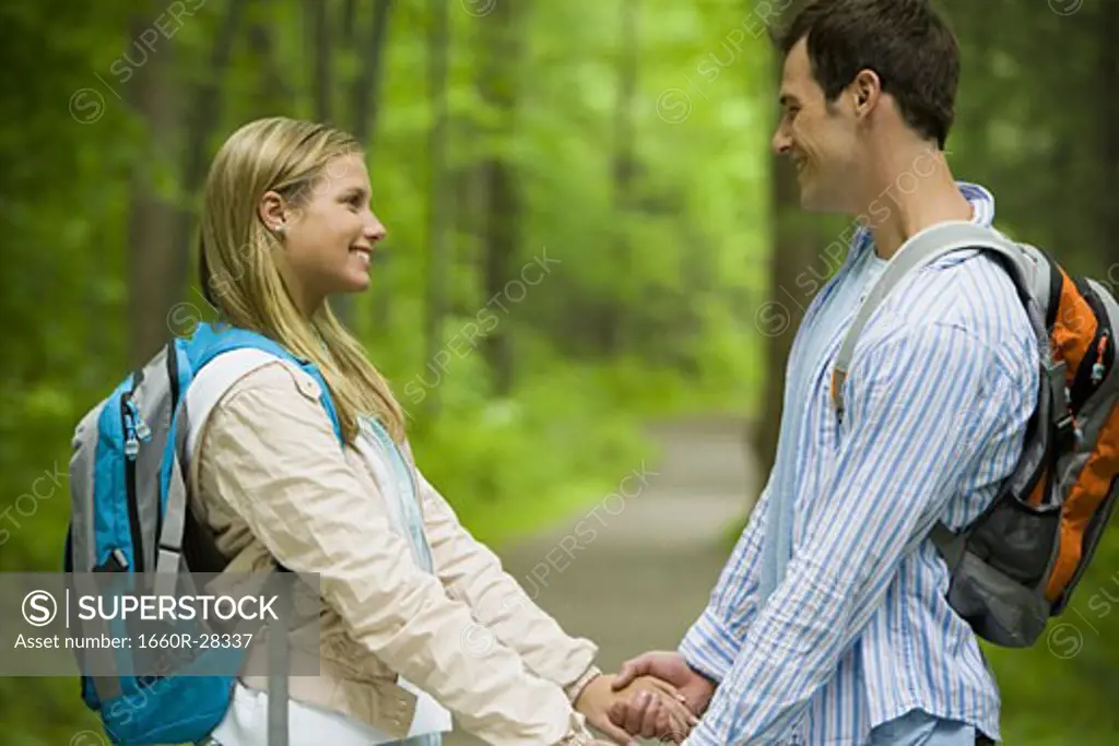 Profile of a young couple looking at each other and smiling