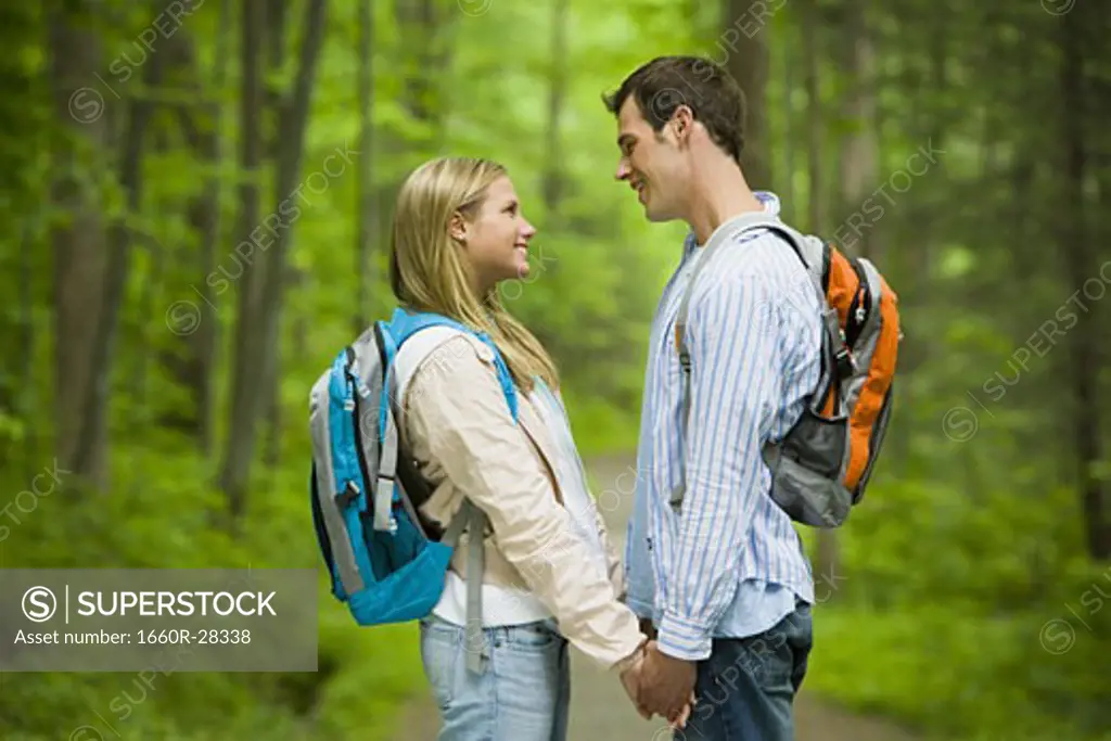 Profile of a young couple looking at each other and smiling