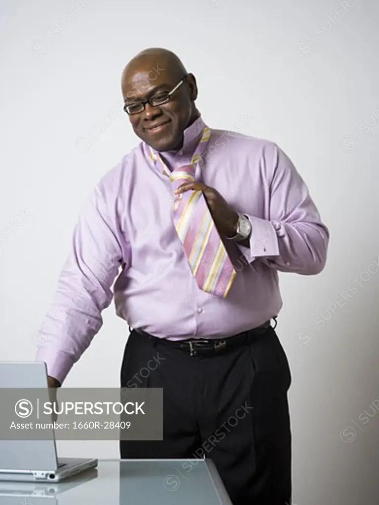 Portrait of a businessman tying his tie