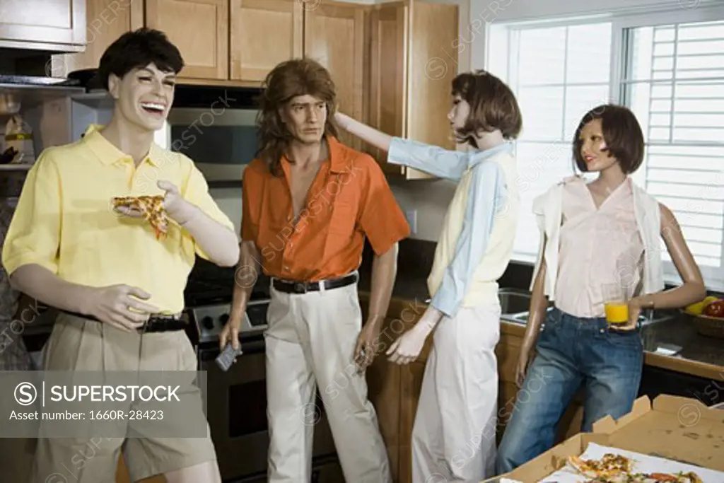 Five mannequins portraying a family in the kitchen