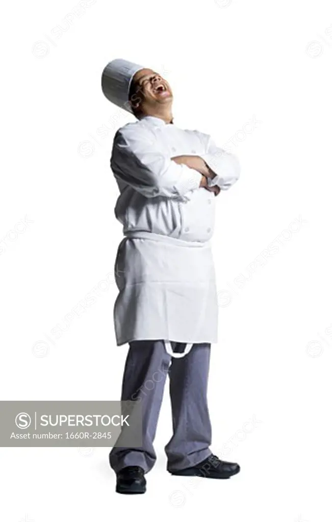 Male chef standing with his arms folded
