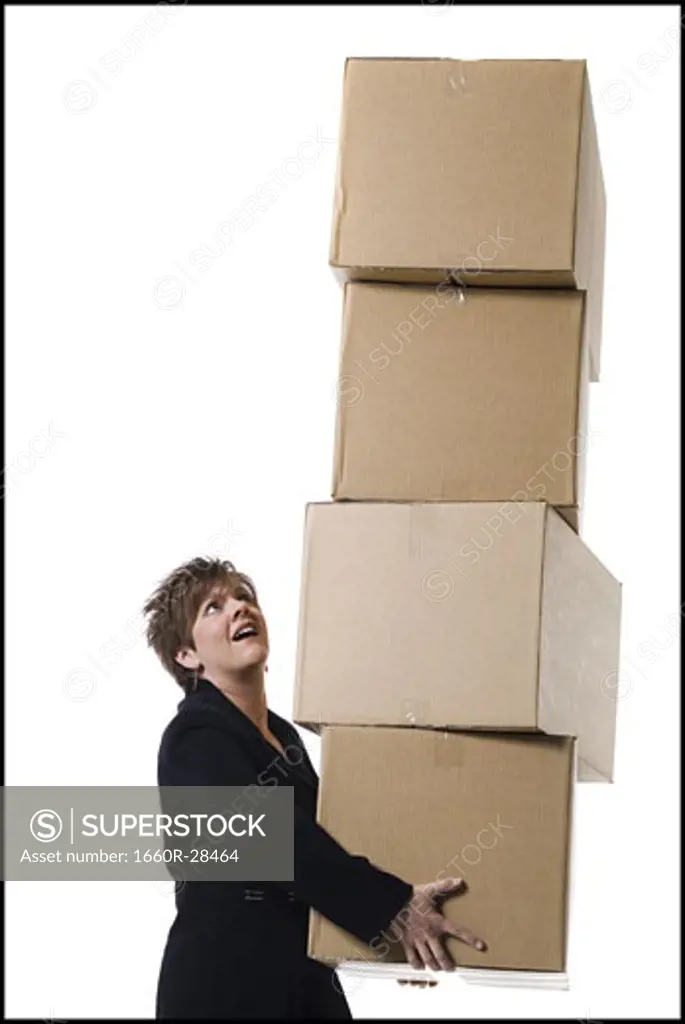 Profile of a senior woman holding a stack of cardboard boxes