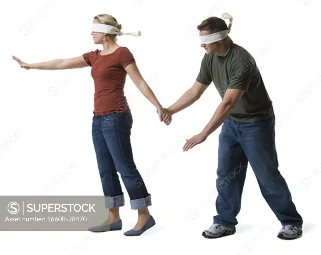 Blindfolded young woman leading to a blindfolded young man