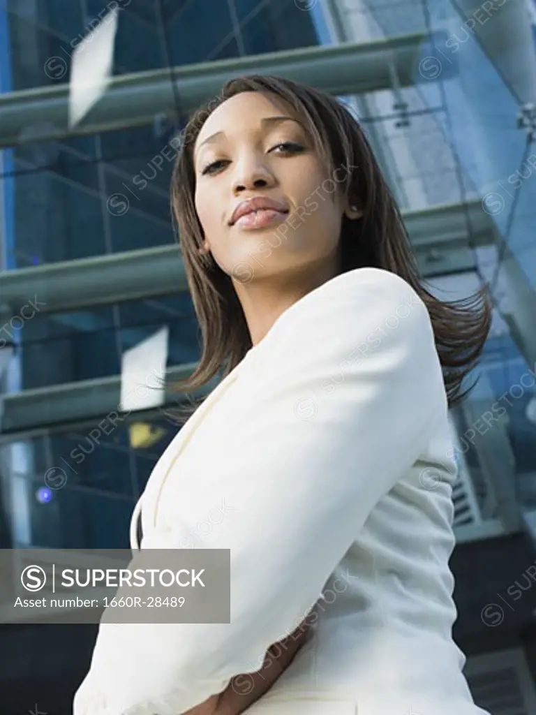 Portrait of a young businesswoman standing in front of a building