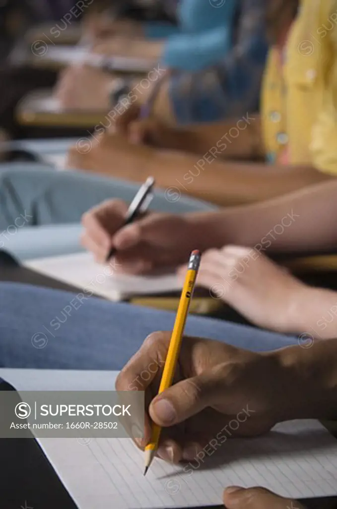 College students writing and taking notes