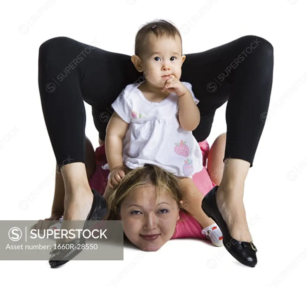 Contortionist mother with baby daughter
