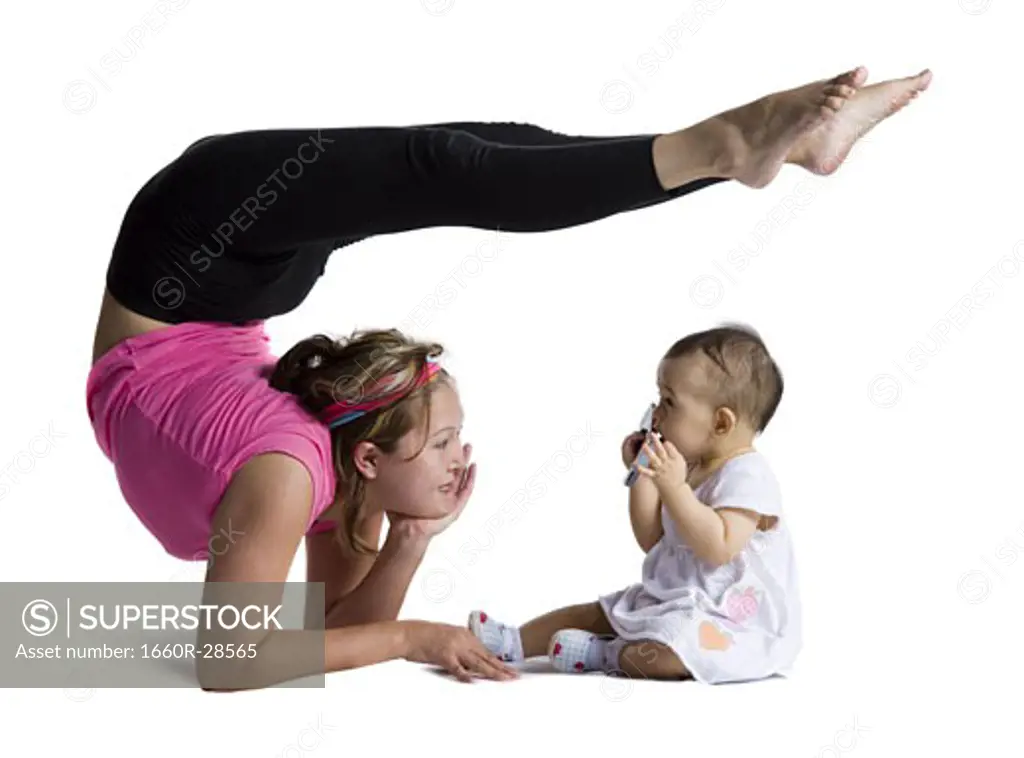 Contortionist mother with baby daughter