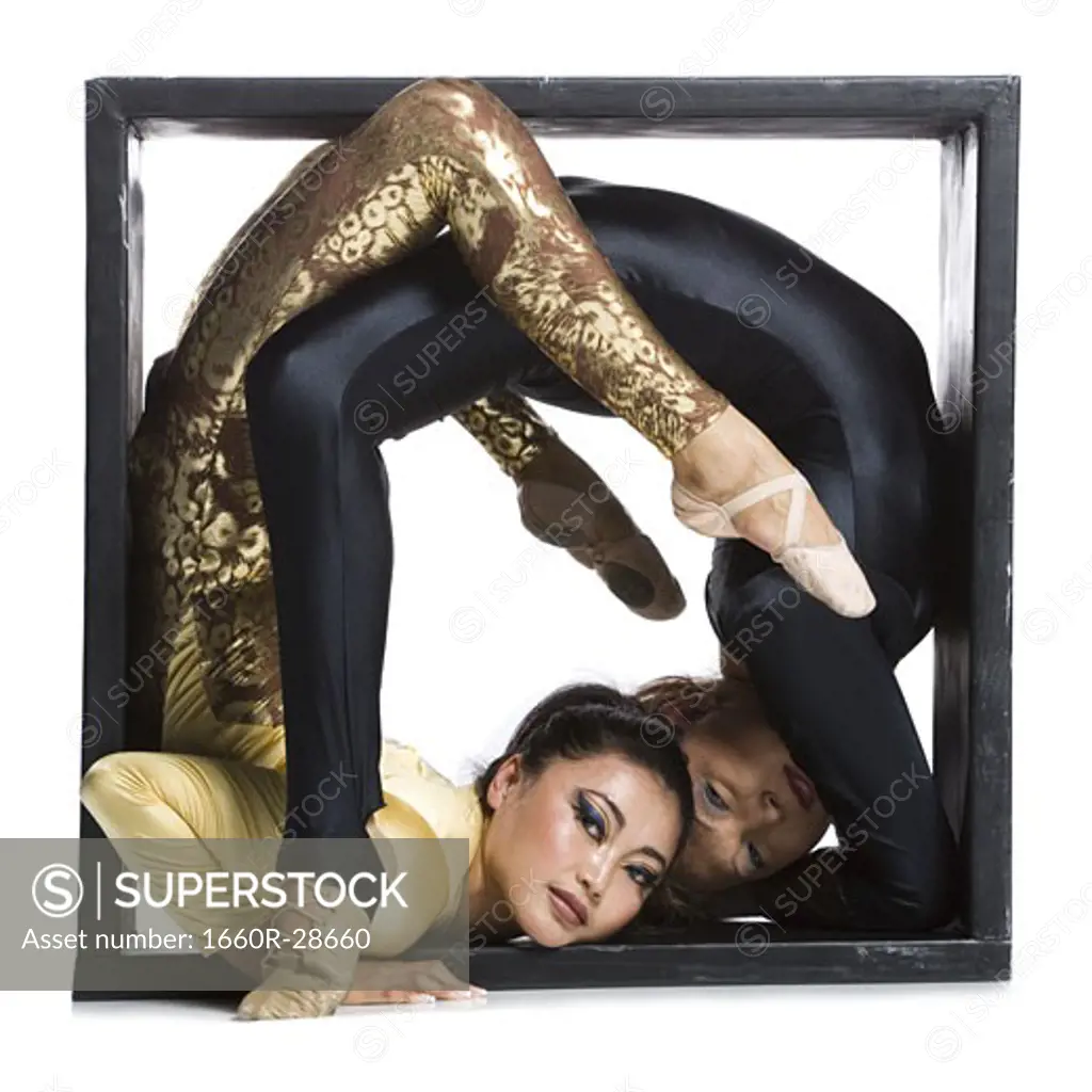 Female contortionist duo inside the box
