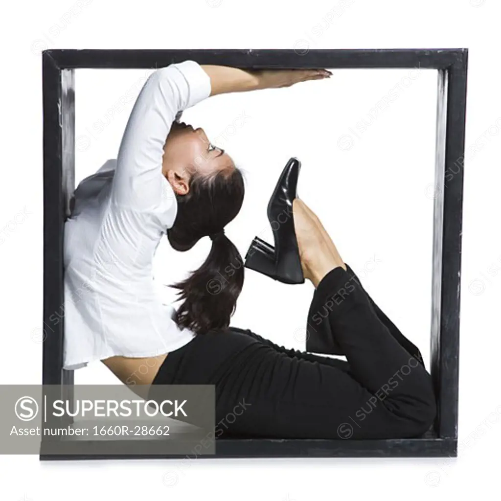 Female contortionist businesswoman inside the box
