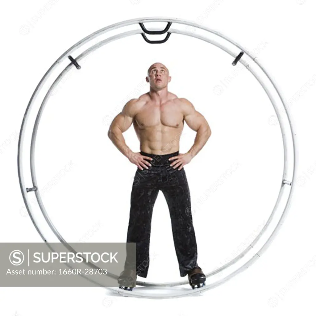 Male bodybuilder posing in German wheel