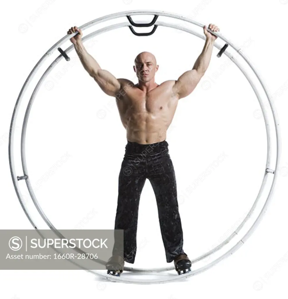 Male bodybuilder posing in German wheel
