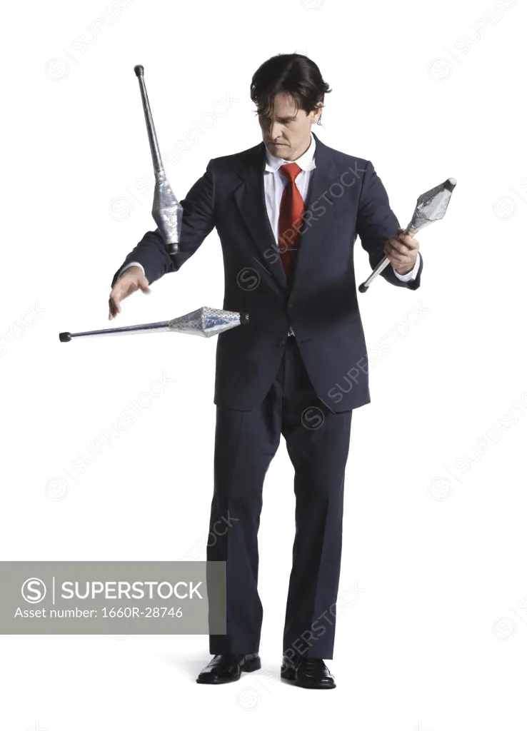 Businessman juggling pins