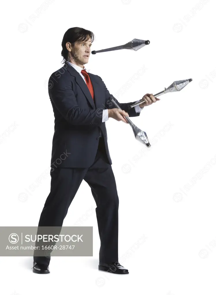 Businessman juggling pins