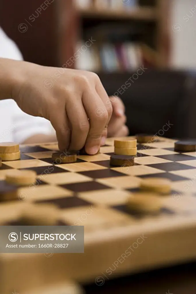 Young boy playing checkers