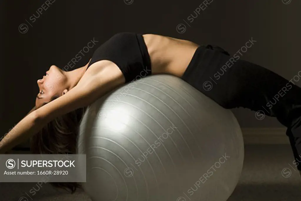 Woman performing Pilates exercises