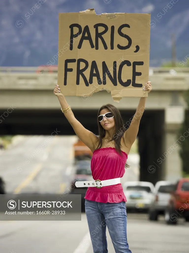 Woman hitchhiking a ride to Paris