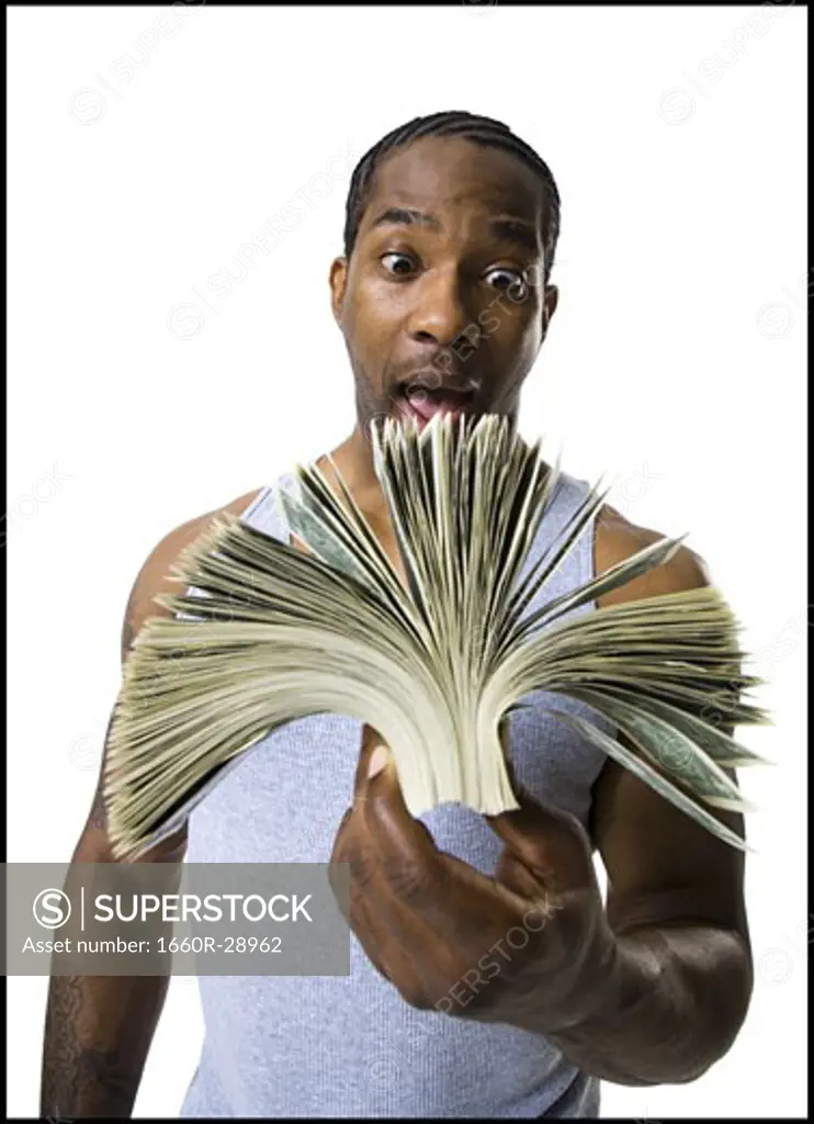 African American holding a pile of dollar bills