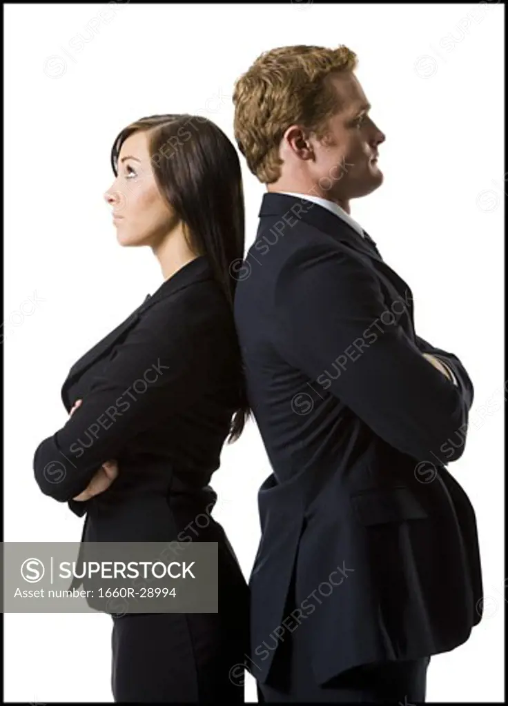 Businessman and businesswoman standing back to back