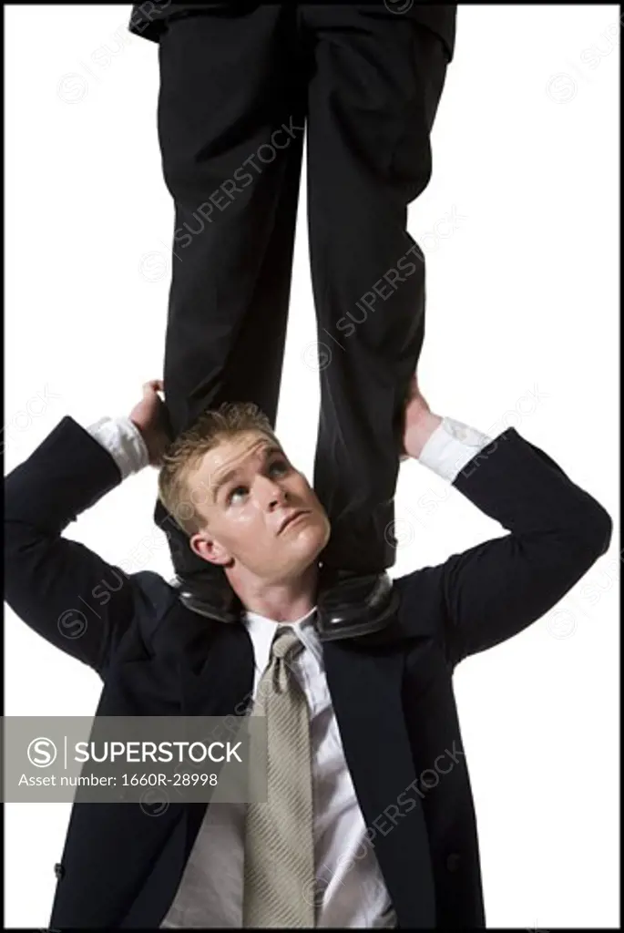 Businessman supporting colleague on shoulders