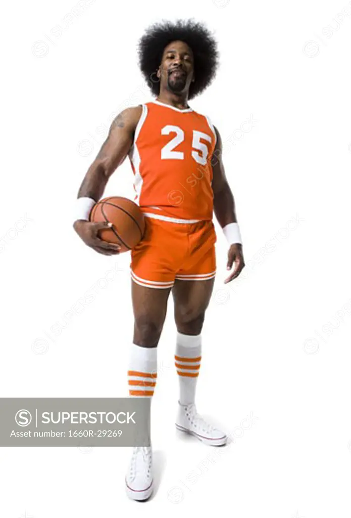 Basketball player with an afro in orange uniform