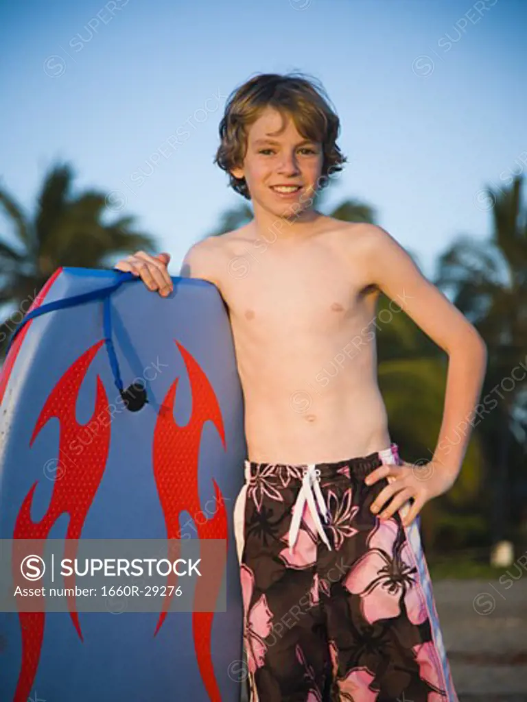 Boy on beach with boogie board
