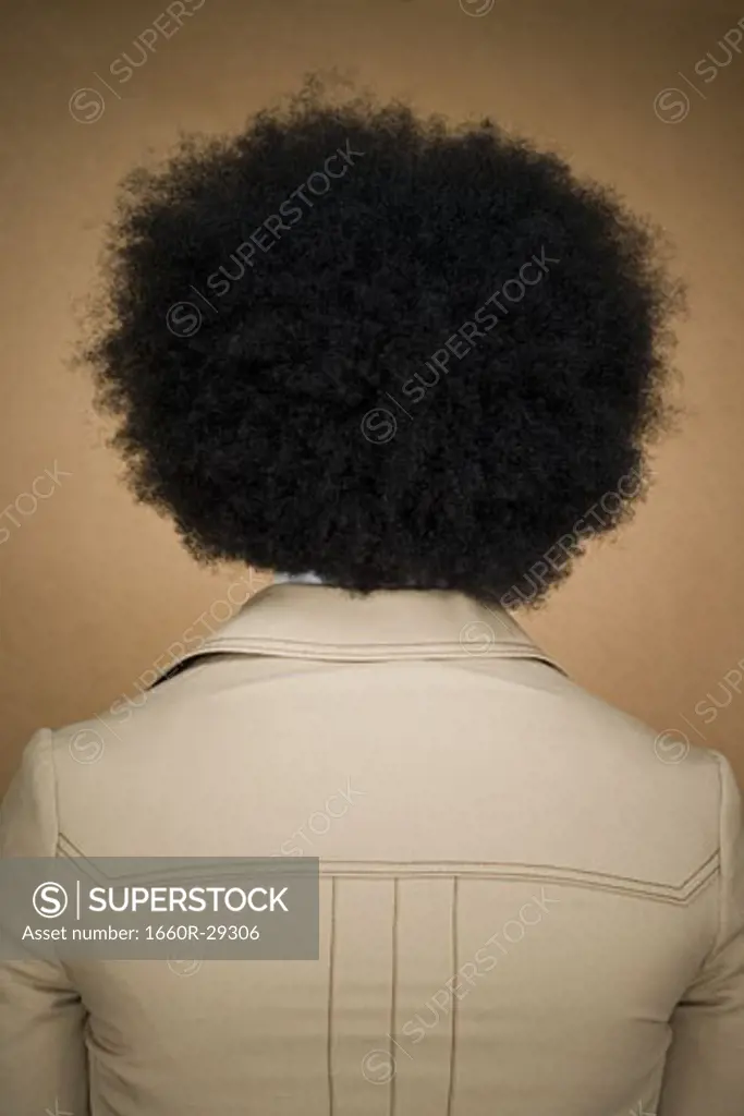 Man with an afro in beige suit