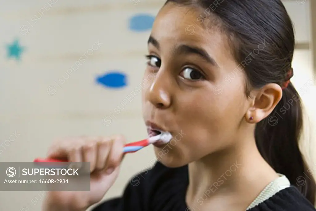 Close-up of a girl brushing her teeth