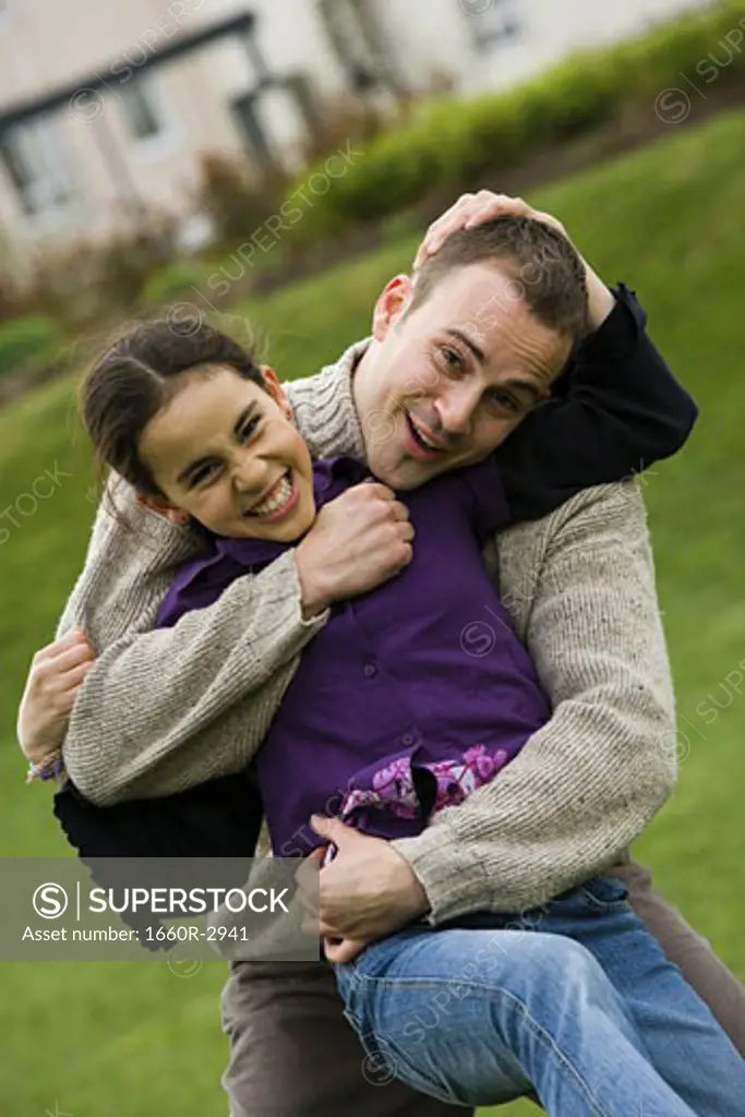Portrait of a father hugging his daughter