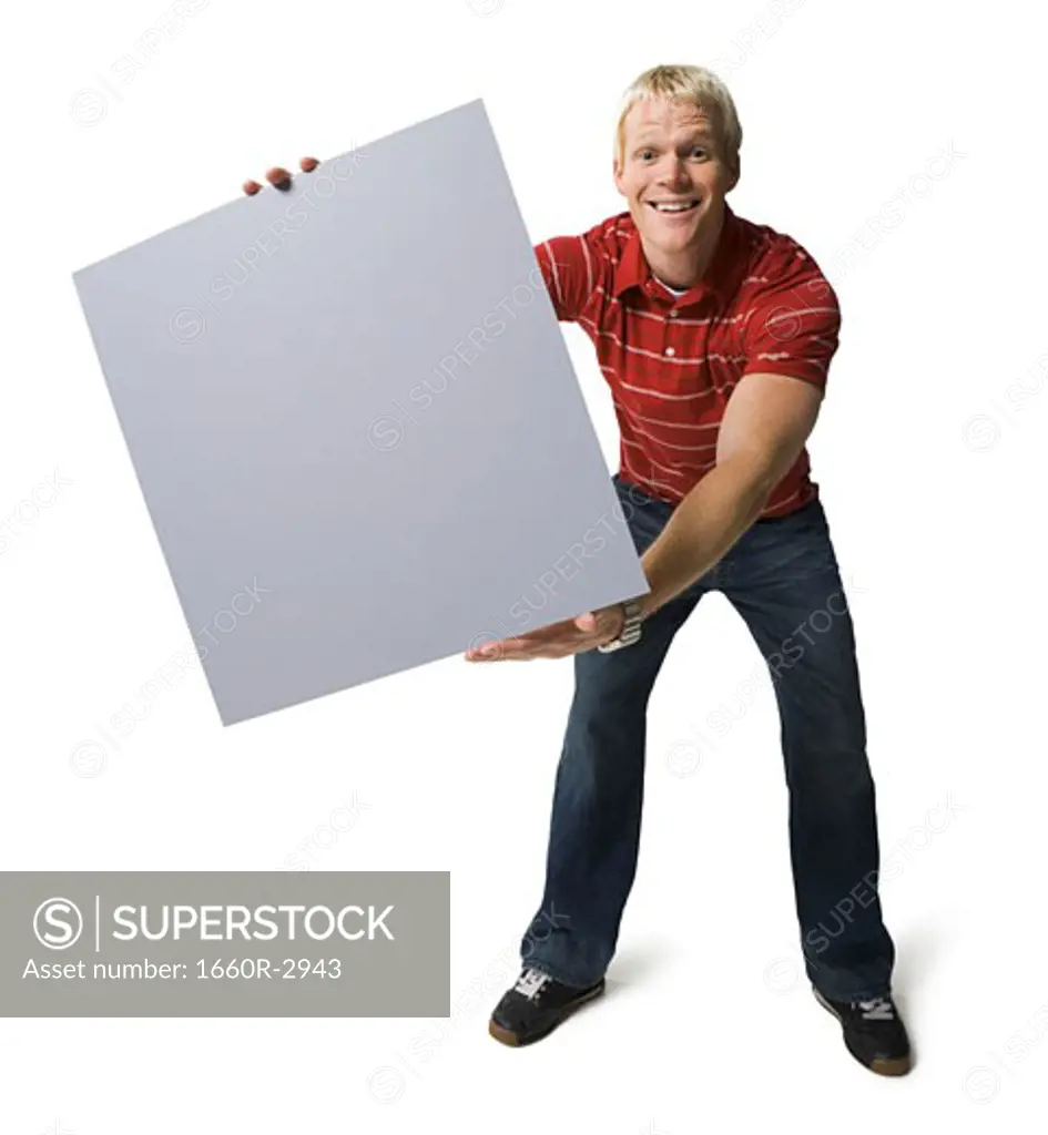 Portrait of a young man holding a blank sign