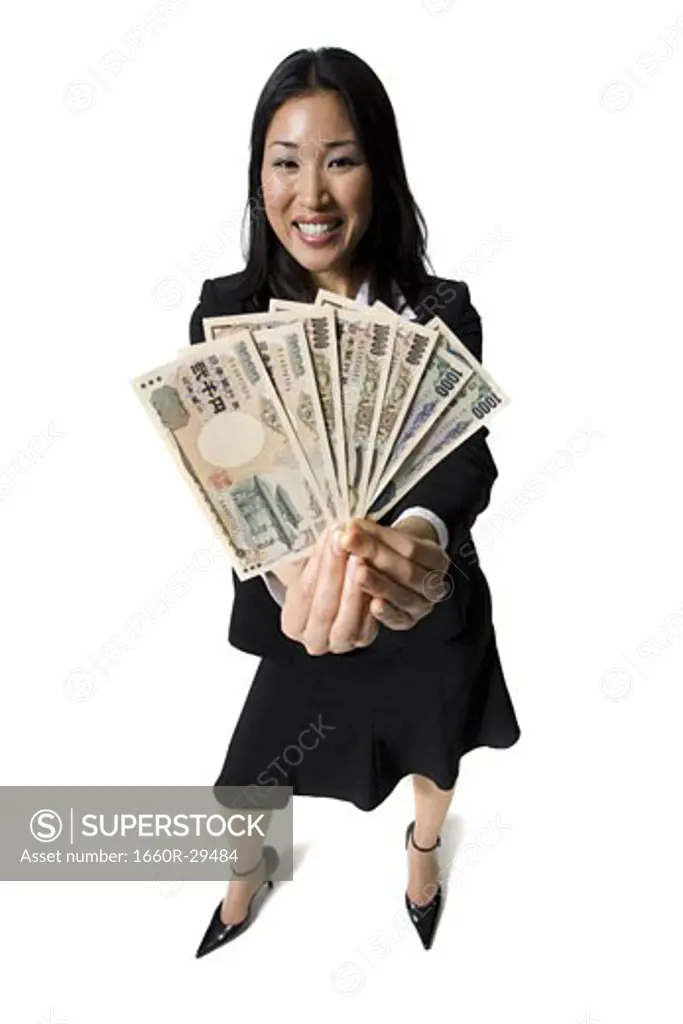 Businesswoman holding Yen banknotes