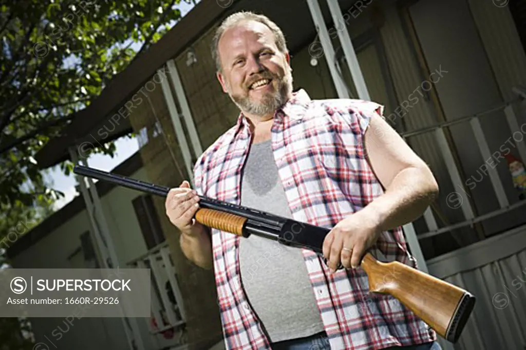 Overweight man with a shotgun