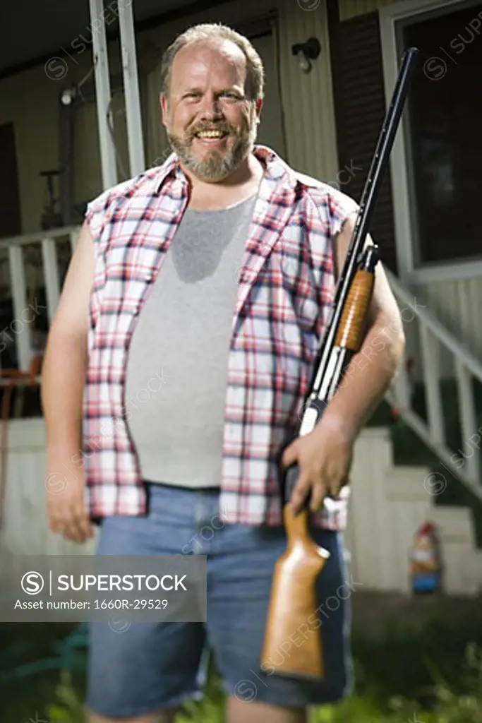 Overweight man with a shotgun