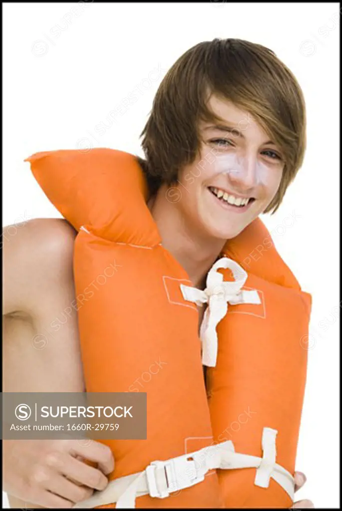 Boy in swim trunks with life vest