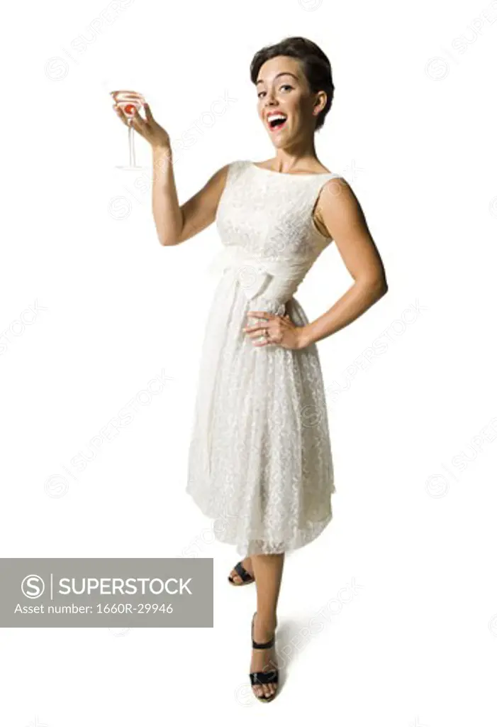 Woman in white dress holding martini glass
