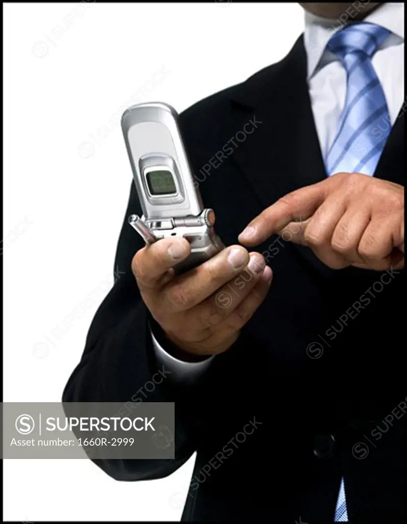 Mid section view of a businessman using a mobile phone