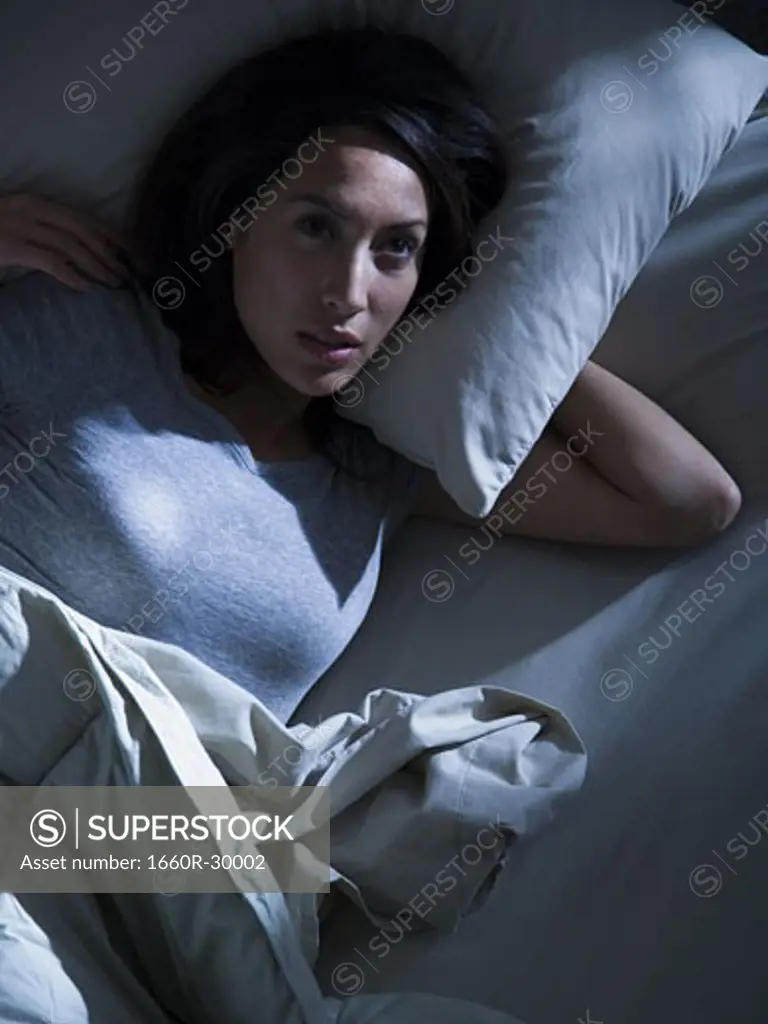 Woman in bed in the dark