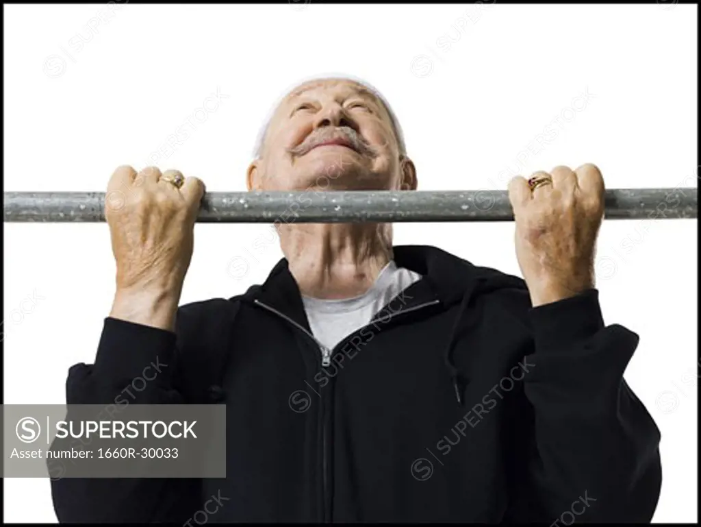 Older man doing chin up exercises