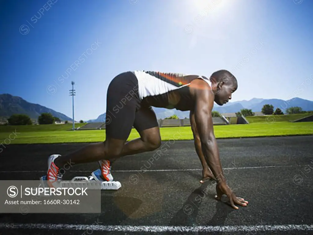 Track runner in starting position ready to race