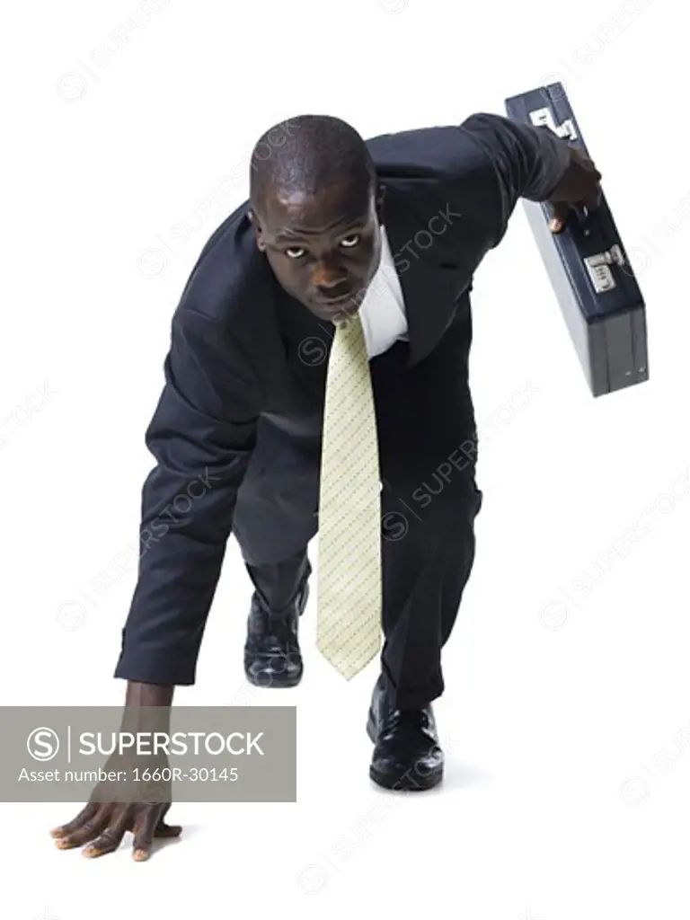Businessman in starting position ready to race