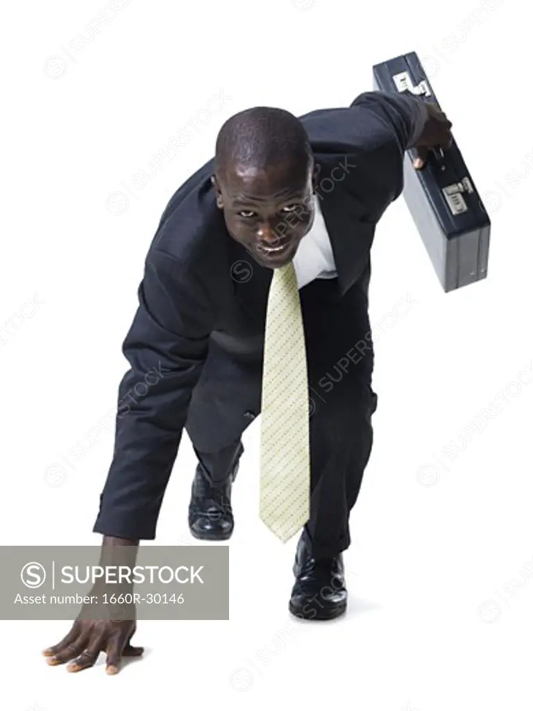 Businessman in starting position ready to race